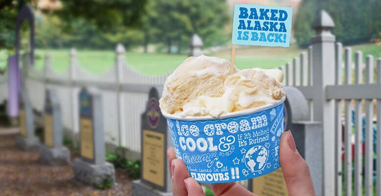 A cup of Baked Alaska being held in the graveyard